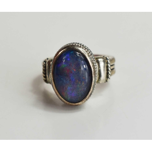 130 - An Indian silver and black opal ring, the opal of approximately 13.5 by 9.5mm, size N.