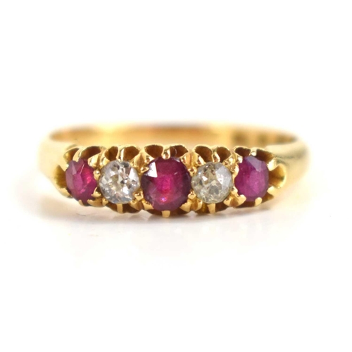 135 - An 18ct gold, ruby and diamond five stone ring set with three rubies, two diamonds, size N, 2.6g.