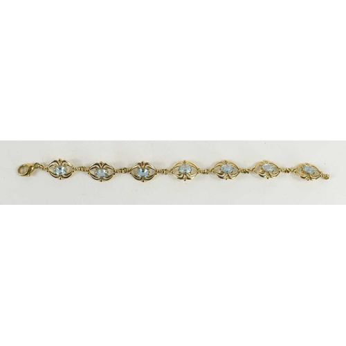 136 - An Art Nouveau style 9ct gold and aquamarine bracelet, of seven panels each with an oval aquamarine ... 