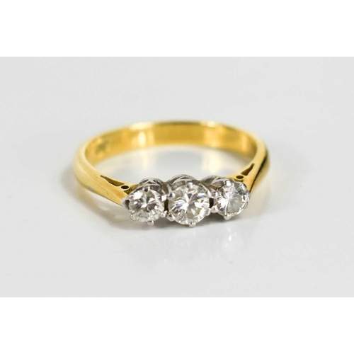139 - An 18ct gold and diamond three stone ring, the central stone of approximately 0.25ct, 3.95mm, with t... 