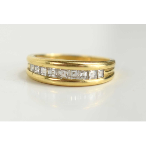 141 - An 18ct gold and diamond half eternity ring, with nine emerald cut diamonds, channel set, size M, 3.... 