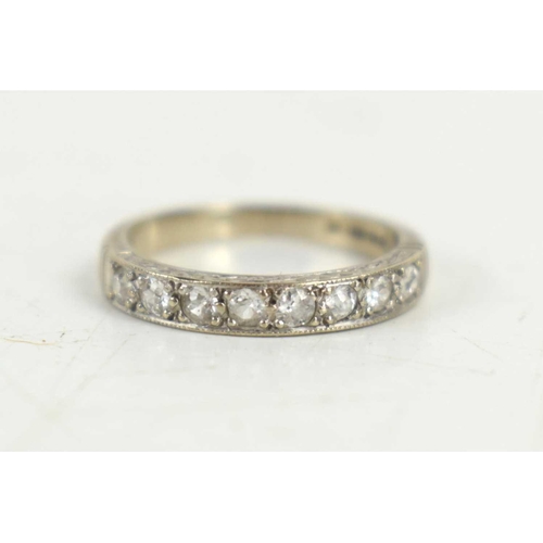 142 - An 18ct white gold half eternity ring, size K, 2.9g. 