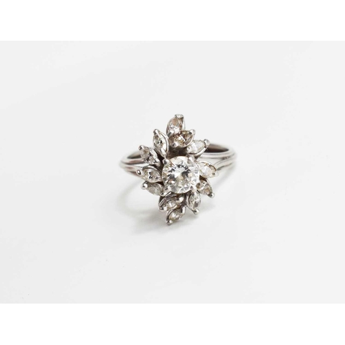 148 - A vintage diamond dress ring, of flowerhead form, the central stone of approximately 0.7ct, 5.7mm di... 