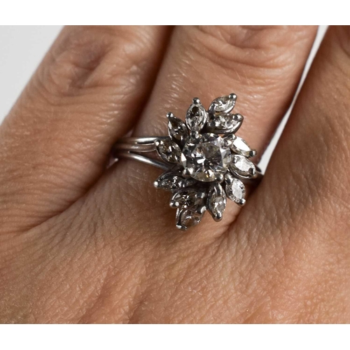 148 - A vintage diamond dress ring, of flowerhead form, the central stone of approximately 0.7ct, 5.7mm di... 