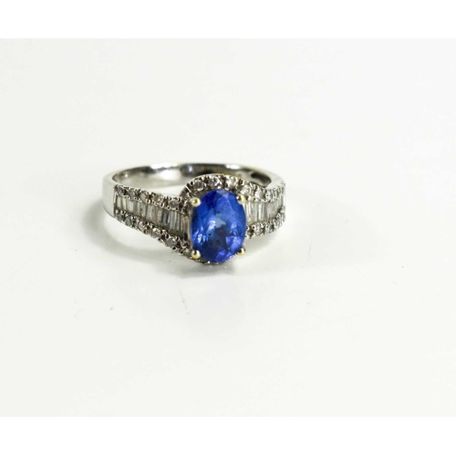 150 - An 18ct white gold ring set with tanzanite and baguette cut diamonds, oval cut stone 1.25ct, 3.8g.