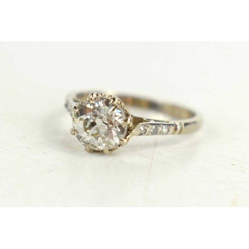 154 - An 18ct white gold solitaire ring, with old cut diamond set to the shoulders, on a platinum shank, d... 