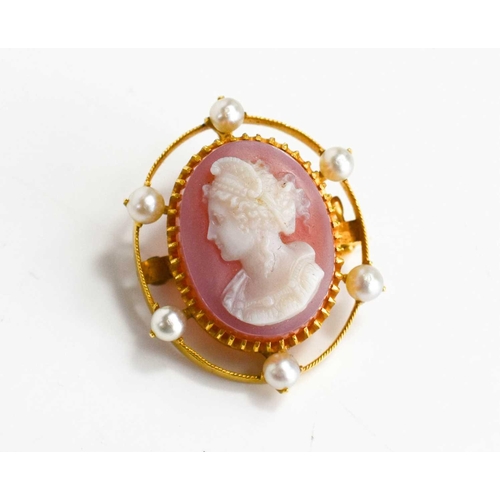 156 - A gold, cameo and pearl brooch of oval form, the cameo depicting a female profile portrait, in a gol... 