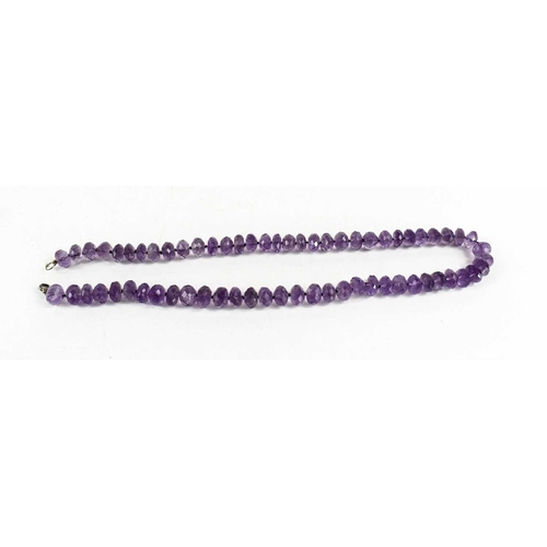 161 - An amethyst beaded necklace, each bead facet-cut, with crab claw clasp, 56cm long.