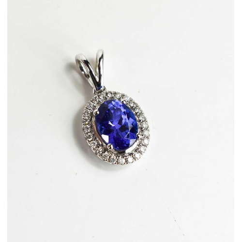 175 - An 18ct white gold pendant set with a single tanzanite stone, 1.25ct and surround by diamonds, 1.7g.