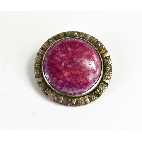 178 - A Ruskin pottery and silver brooch, the pink plaque set in a decorative silver border, 3cm diameter.