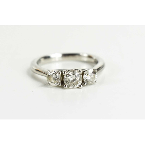 23 - A 950 platinum & diamond three stone ring, the central stone of approximately ½ct, adjoined by ¼ct t... 