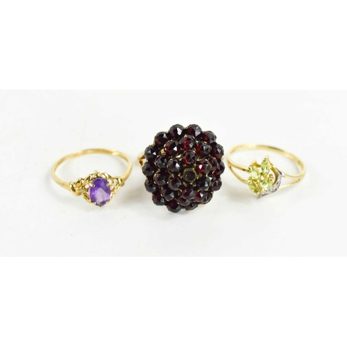 247 - Three 9ct gold rings; one garnet and cluster ring 4.33g, size N½, one set with amethyst, the other p... 