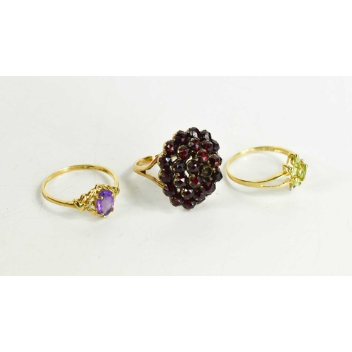 247 - Three 9ct gold rings; one garnet and cluster ring 4.33g, size N½, one set with amethyst, the other p... 