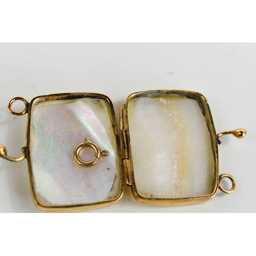 25 - A gold and mother of pearl miniature purse / trinket box, unmarked but testing as at least 9ct gold,... 