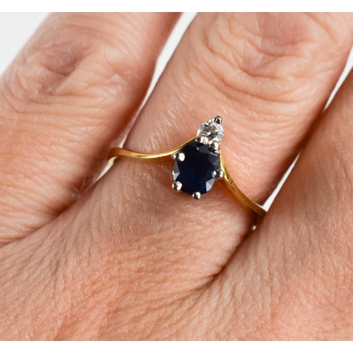 258 - An 18ct gold sapphire and diamond wishbone ring, the oval cut dark sapphire of approximately 4.2 by ... 