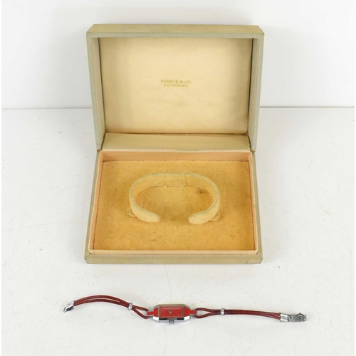 261 - An Art Deco ladies watch with red enamel dial, red cord strap, inside a Shreve & Co case.