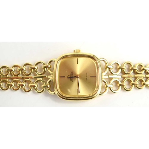 293 - A lady's 18ct gold Omega De Ville wristwatch with integral 18ct gold open link strap, 16cm long incl... 