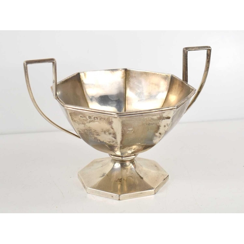 298 - A silver twin handled pedestal bowl of octagonal form, hallmarked for Birmingham, 13cm high, 9.4toz