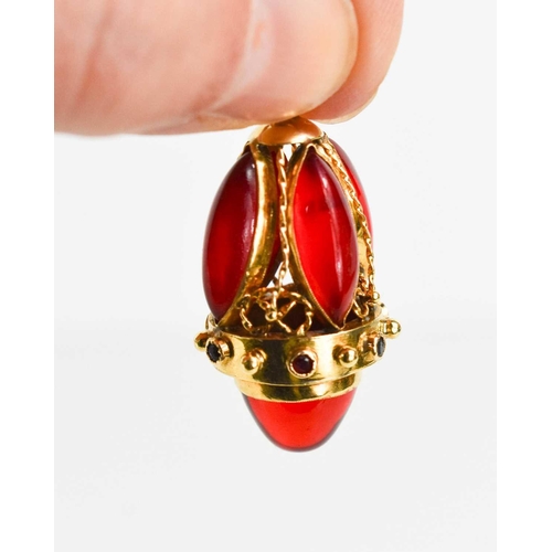 3 - A gold egg form pendant, set with red gemstone cabochons, 3.5cm to the top of the hoop, unmarked but... 