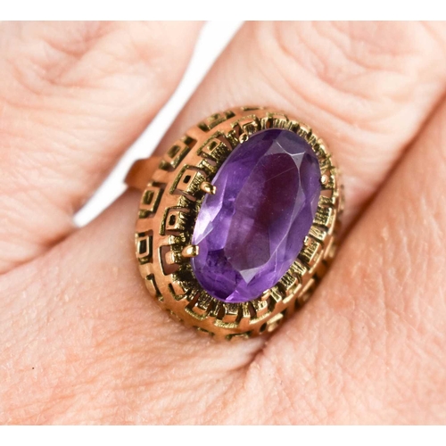 33 - A large oval set amethyst ring, in raised pierced setting, the stone approximately 7.3 by12.9mm, sha... 