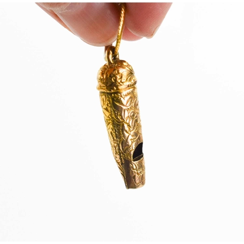 35 - A small gold whistle, unmarked but testing as at least 9ct gold, engraved with chased decoration, on... 