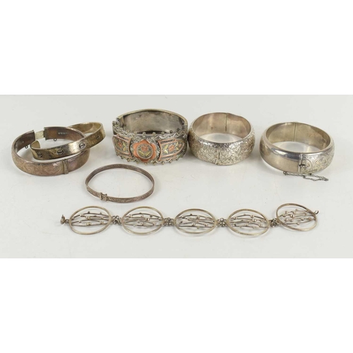 371 - A silver bracelet of five circular panels with abstract bead and strand design, a silver cuff bangle... 