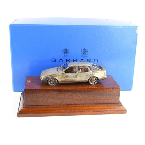 416 - A silver Ford Scorpio by Garrard & Co, presented to Coxes Motors of Leicester by Ford for selling th... 