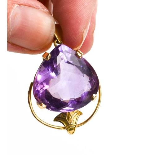 45 - An amethyst set pendant, the single trillion cut stone of approximately 20.5 by 20.5mm in Art Nouvea... 