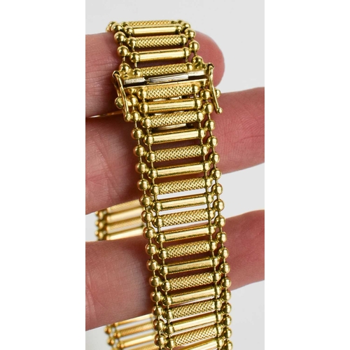 46 - A 14ct gold bracelet of alternating engraved and smooth interconnected column links, 21cm long, 34.0... 