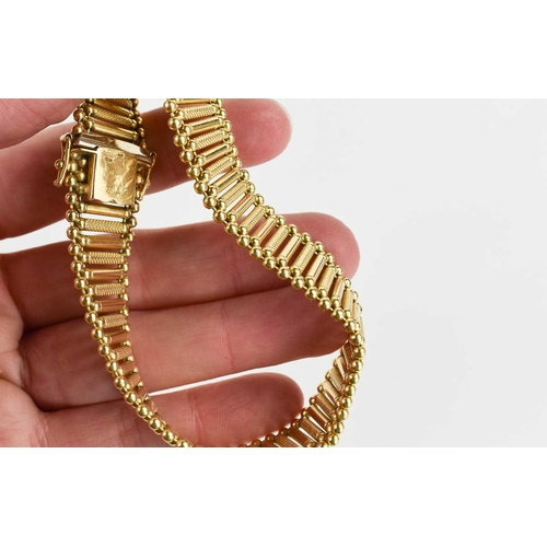 46 - A 14ct gold bracelet of alternating engraved and smooth interconnected column links, 21cm long, 34.0... 