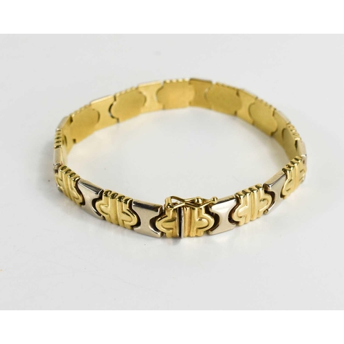 48 - A bi-colour 9ct gold bracelet of abstracted 'x' and snaffle form, 19cm long, 14.97g.