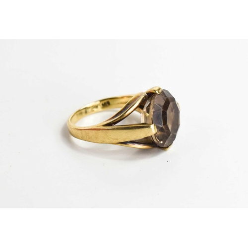 57 - A 9ct gold and smokey quartz dress ring, the circular facet cut quartz in a modern style setting, si... 
