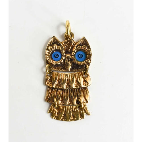 6 - A 14ct gold reticulated owl form pendant, with blue enamel eyes, and engraved detail, 13.8cm tall to... 