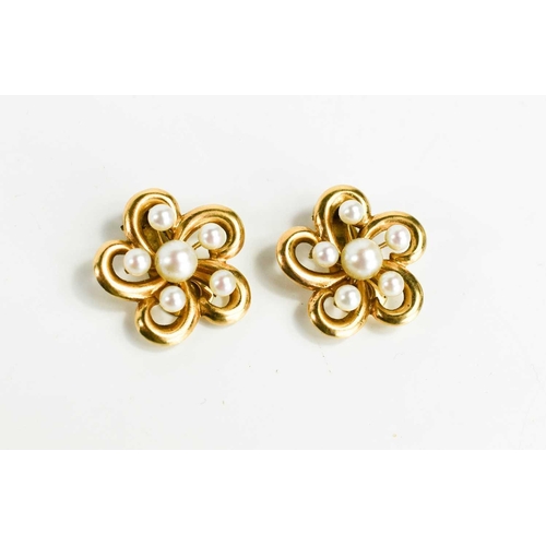 69 - A pair of 14k gold an pearl clip on earrings, of flowerhead form, 11.5g, 2.5cm wide.