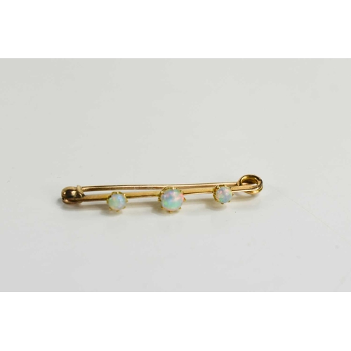 8 - A Victorian 15ct gold and opal three stone bar brooch, 2.5g, 4cm long.