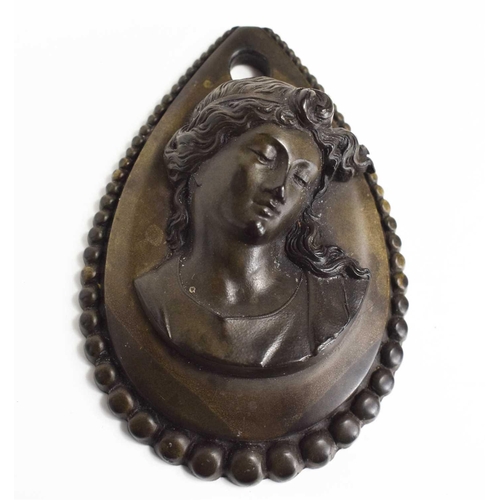 85 - A Victorian ebony mourning pendant, of teardrop form, carved with a female bust, 6.5 by 4.5cm.