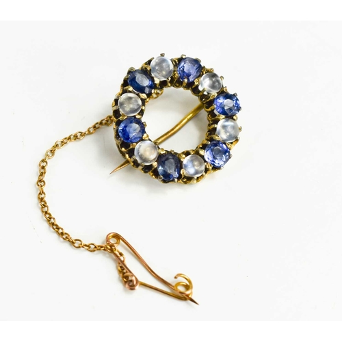 9 - A Victorian sapphire and moonstone brooch of circular form, set with six cornflower blue sapphires a... 