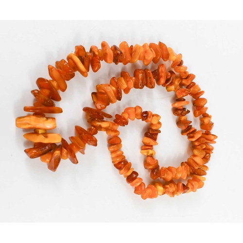 97 - An amber necklace, composed of rough cut graduated amber beads, 123g, 90cm long.