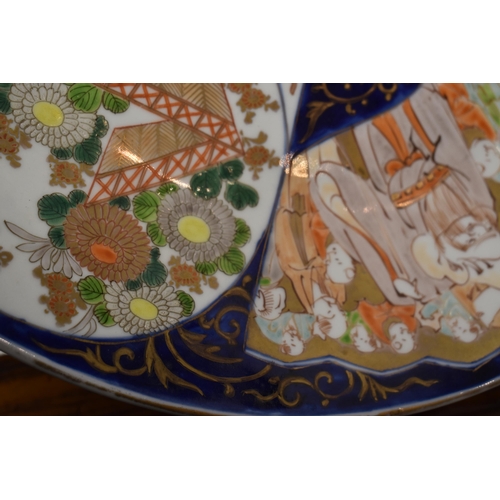 295 - A pair of large Japanese Imari chargers, the 19th century chargers measure 46cm diameter, with secti... 