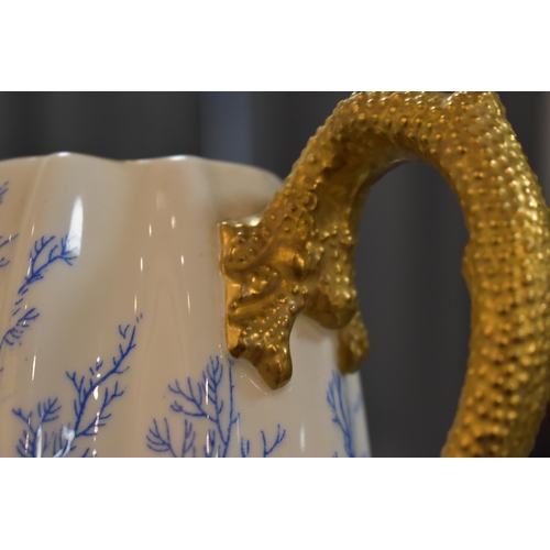 287 - A 19th century Coalport part coffee set, decorated with blue coral and gilded handles and rims.