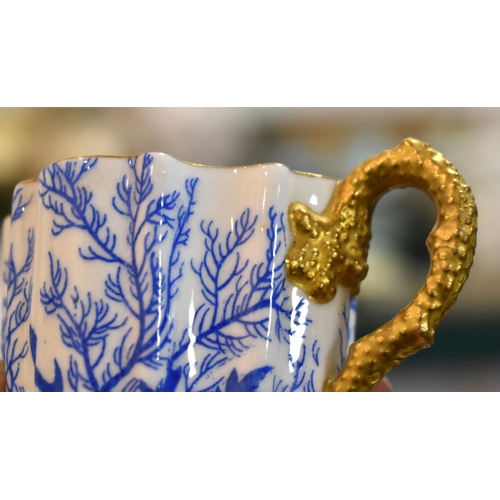 287 - A 19th century Coalport part coffee set, decorated with blue coral and gilded handles and rims.