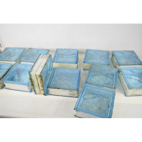 163 - A group of twelve glass bricks, each of square form, triple glazed with sea blue glass, 19 by 19 by ... 