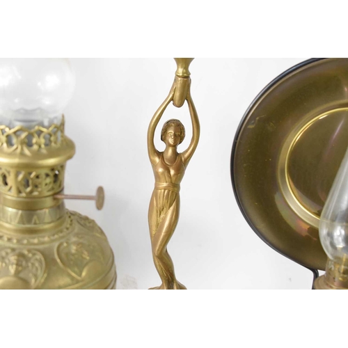 169 - An Art Nouveau oil lamp in the form of a classical lady holding the burner and bowl aloft together w... 