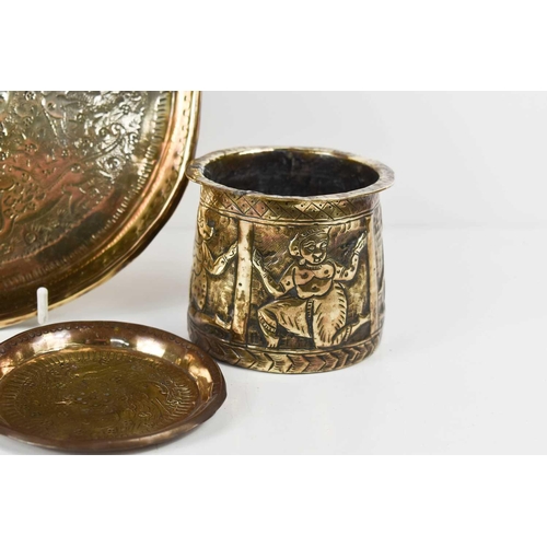 183 - An early Indian brassware cup with flared rim, embossed with figures; one with the head of an animal... 