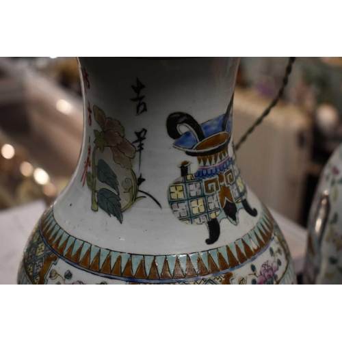 319 - A pair of 19th century Chinese vases, converted to lamps, the enamel decoration depicting flowers, C... 