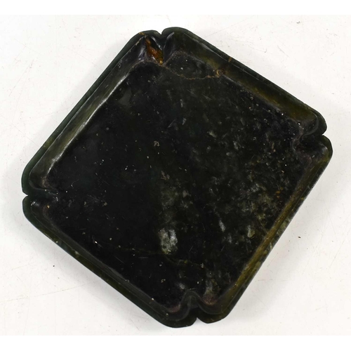 333 - An antique Chinese spinach jade dish, with recessed corners, 12.5cm by 11.5cm.