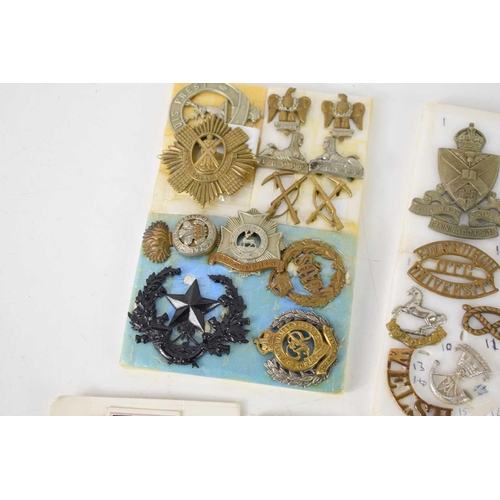 37 - A group of cap and collar badges, including a pair of WWI, Northumberland Fusiliers badges, with ide... 