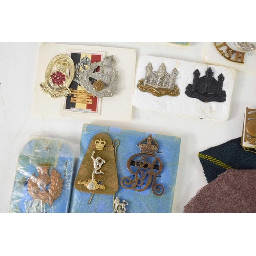 37 - A group of cap and collar badges, including a pair of WWI, Northumberland Fusiliers badges, with ide... 