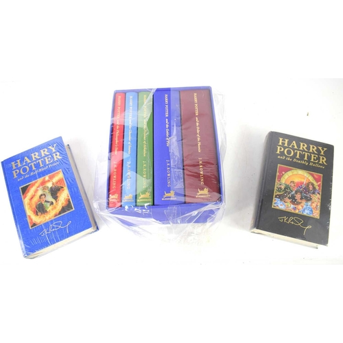 371 - A set of Harry Potter Deluxe edition books, the first five volumes bound in coloured fabric and enca... 