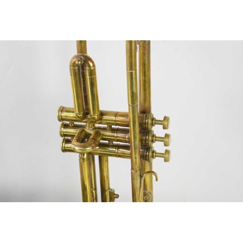 448 - A vintage brass trumpet having mother of pearl panels to finger buttons inside a velvet lined case, ... 